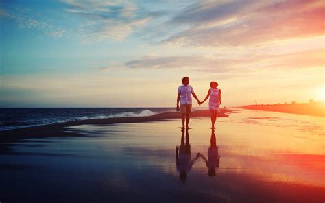 Download Aesthetic Couple In Wet Beach Sand Wallpaper