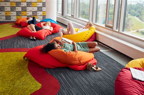 Diverse People In Modern Office Power Napping During Lunch Break Stock