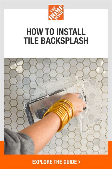 A Person Is Using A Tile Back Splash To Fix The Backsplash On A Wall