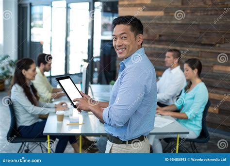 Portrait Of Smiling Businessman Using Digital Tablet Stock Image