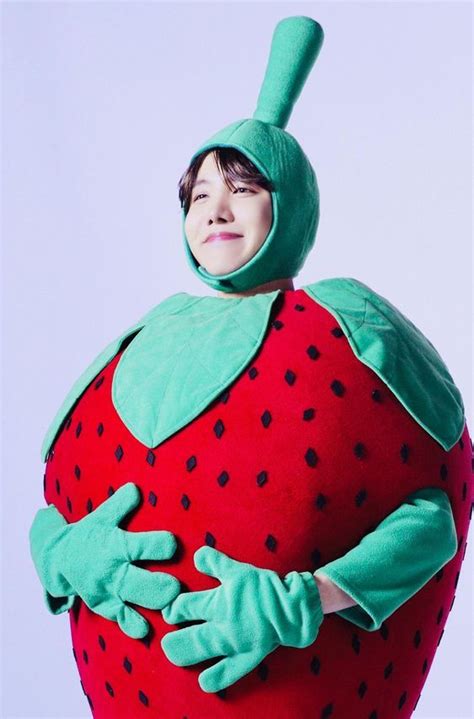 A Person In A Costume That Looks Like A Strawberry