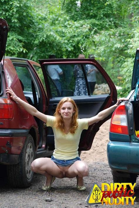 Naughty Redhead Showing Her Pussy In Car Park Photos