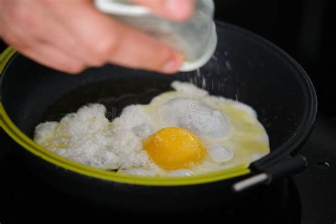 Male Hand Adding Salt To Egg In Frying Pan Stock Image Image Of Cooking Yellow 254298501