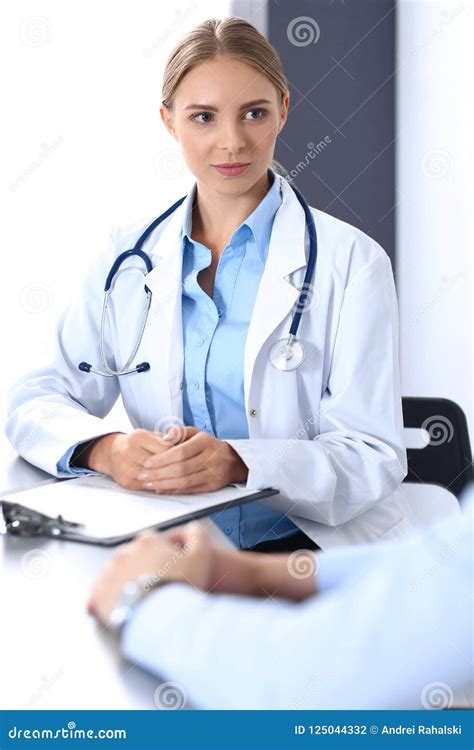 Doctor And Patient In Hospital Beautiful Blonde Physician Consulting Business Man About His