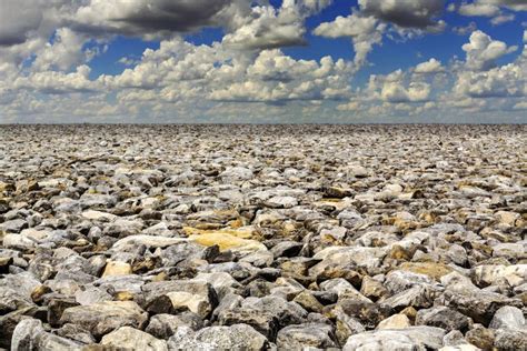 Barren Rocky And Desolate Landscape Under A Cloudy Sky Stock Image