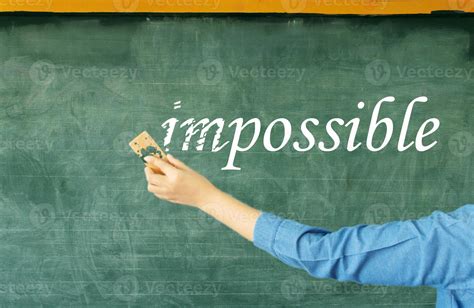 hand erasing prefix of impossible on chalkboard 13394586 Stock Photo at Vecteezy