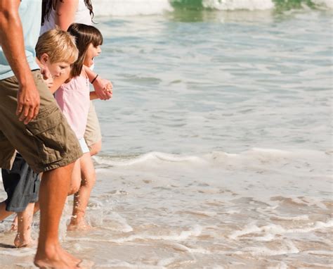 Premium Photo | Family walking on the beach