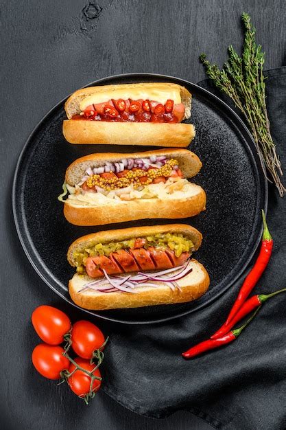 Premium Photo | Hot dogs fully loaded with assorted toppings on a tray.