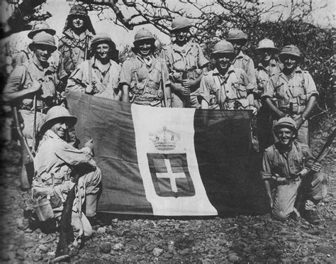 South-African soldiers posing with a captured Italian flag during the