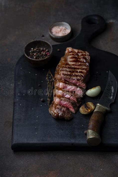 Sliced Grilled Beef Barbecue Striploin Steak With Thyme Stock Image