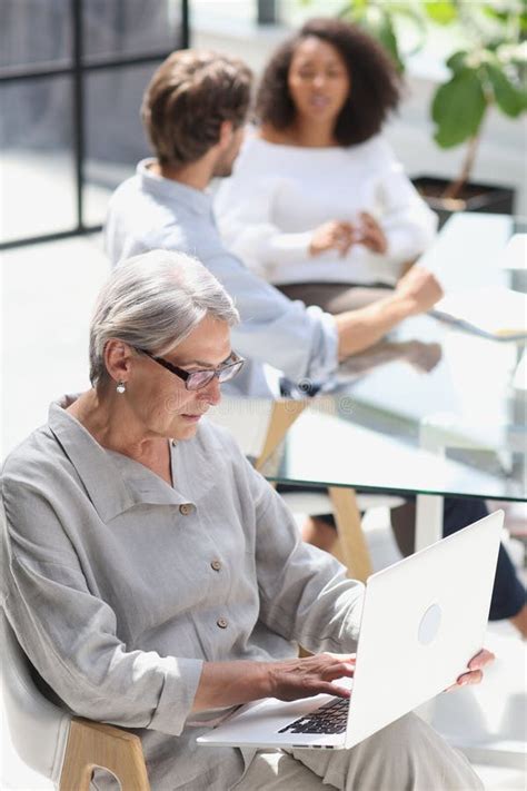 Mature Woman Sitting And Looking At Laptop Stock Image Image Of Human Corporate