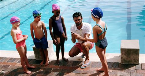 instructor advising children  water safety  swimming lesson