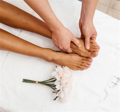 Premium Photo Close Up Of Female Hands Doing Foot Massage