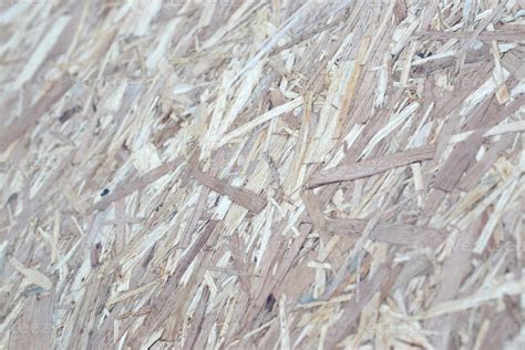 OSB boards made of brown wood chips sanded into a wooden background ...