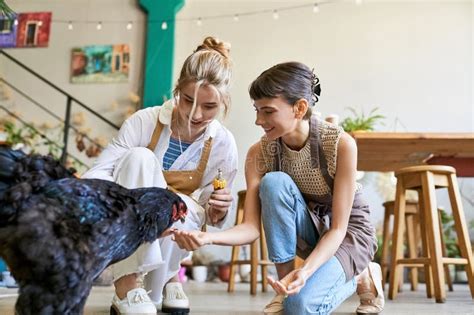 Lesbian Couple Pampering Their Furry Companion Stock Image Image Of Gentle Casual