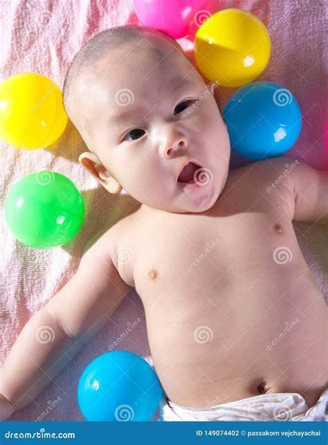 A Happy 3 Months Old Baby In A Bath Of Balls Stock Photo Image Of