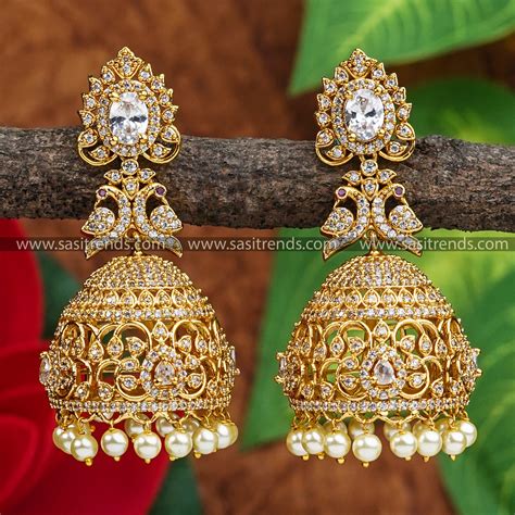 matte gold plated bridal jhumka earrings peacock motif ad stones