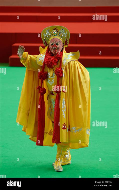 A Performer Wearing Vividly Colored Mask And Costume Performing Bian