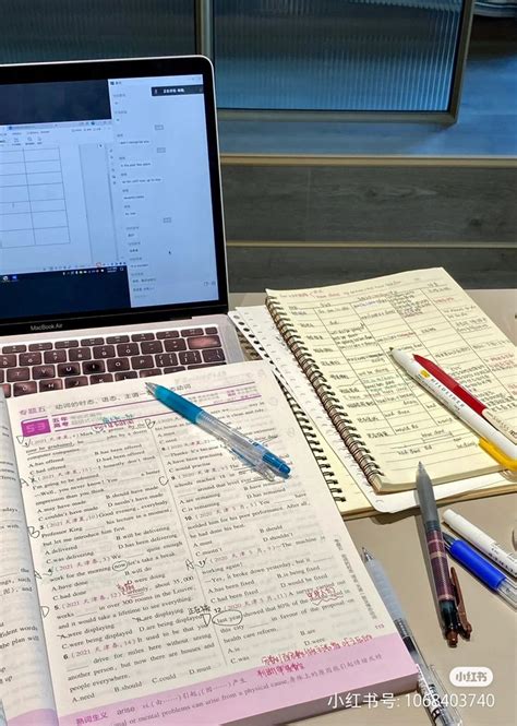 An Open Laptop Computer Sitting On Top Of A Desk Next To Notebooks And Pens