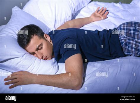 Young Man Sleeping In Bed At Night Stock Photo Alamy