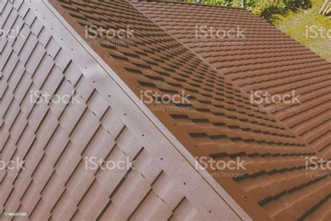 Brown Metal Tile On The Roof Of The House Corrugated Metal Roof Stock