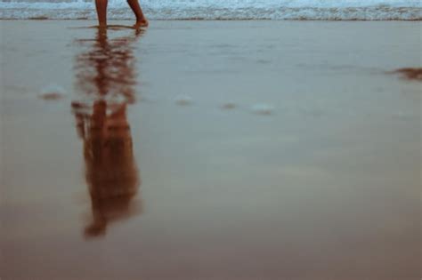 Secci N Baja De Una Persona Caminando Por La Orilla En La Playa Foto