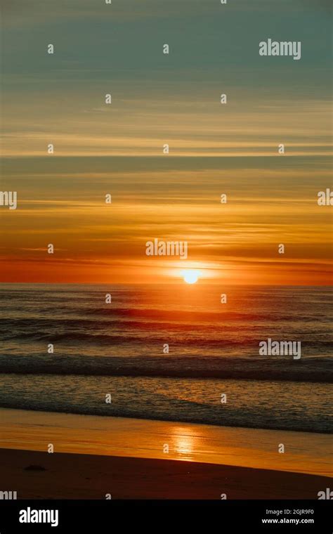 Colorful Ocean Beach Sunrise With Deep Blue Sky And Sun Rays Stock