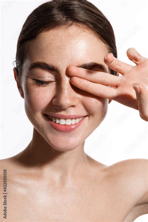 Vertical Shot Of Beauty Woman Naked Touching Fresh And Clean Hydrated Facial Skin Close Eyes