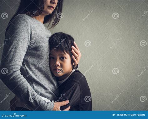 Sad Little Boy Being Hugged by His Mother at Home. Stock Image - Image ...