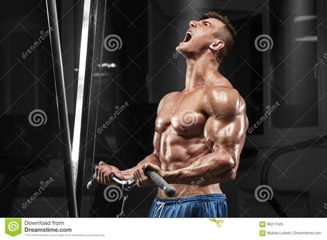 Muscular Man Working Out In Gym Doing Exercises At Biceps Strong Male Naked Torso Abs Stock