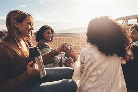 Friends On Road Trip Relaxing Outdoors And Drinking Coffee Jacob Lund