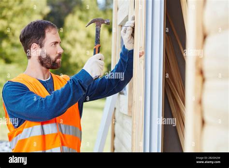 Craftsman Building A House With Hammer And Nail Stock Photo Alamy