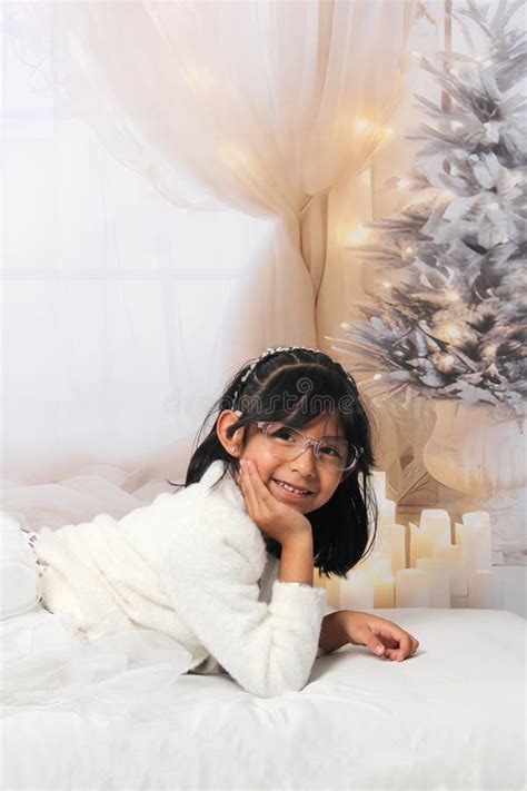 Year Old Latina Girl With Eyeglasses Among Decorated Trees Is Excited To Celebrate Christmas