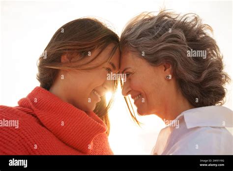 Happy Mother And Daughter Touching Foreheads To Each Other Stock Photo