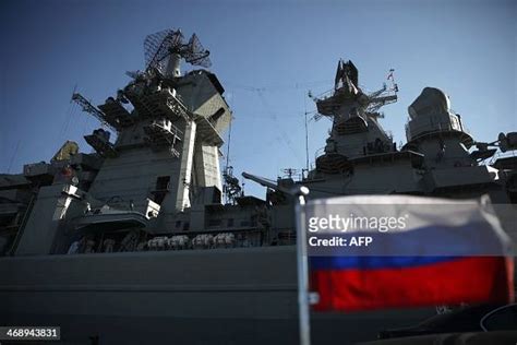 A Russian flag floats in front of the Pyotr Velikiy Russian... News ...