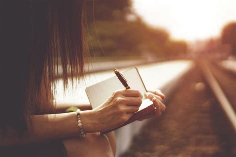 Premium Photo Close Up Of Woman Writing In Book