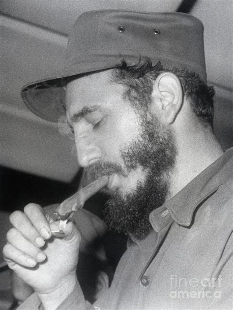 Fidel Castro Lighting A Cigar Photograph by Bettmann