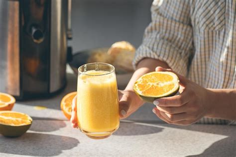 Free Photo A Glass Of Freshly Squeezed Orange Juice And Half An