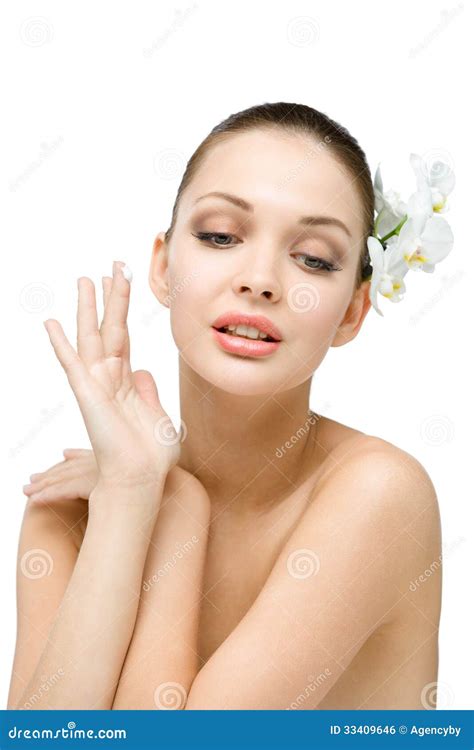 Nude Girl With Orchid In Hair Applies Cream To Her Face Stock Photo Image Of Brunette