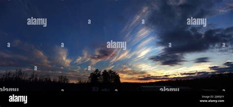 A Silhouette Of Trees Under Cloudy Sky During Sunset Stock Photo Alamy