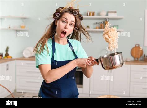 Funny young housewife cooking in kitchen Stock Photo - Alamy