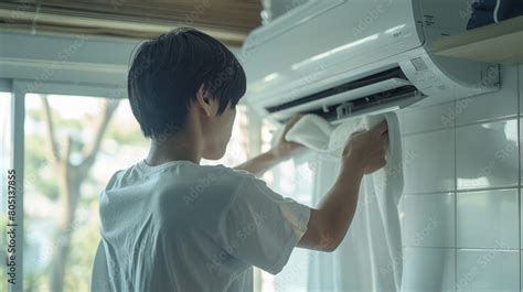 Asian Man Employing A Microfiber Cloth To Clean And Maintain An Air