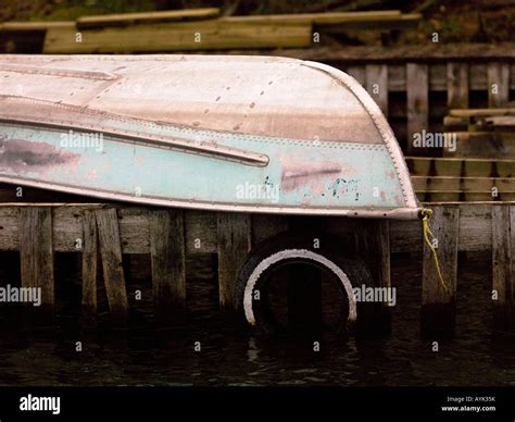 Boat Resting Upside Down On A Dock Stock Photo Alamy