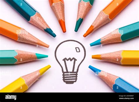 A Light Bulb Surrounded By Colour Pencils As A Symbol Of Creativity And