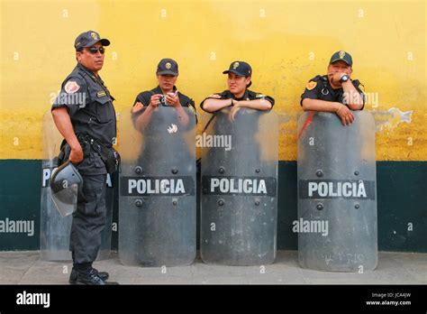 Policemen With Riot Shields Standing By The Wall In Lima Peru