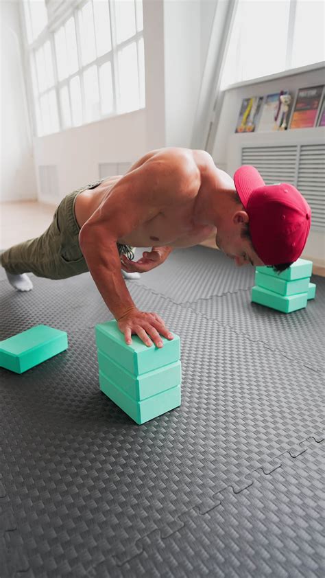 Athletic Muscular Man Naked To The Waist Doing Push Ups In The Gym