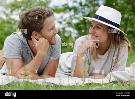 young couple laying in grass Stock Photo - Alamy