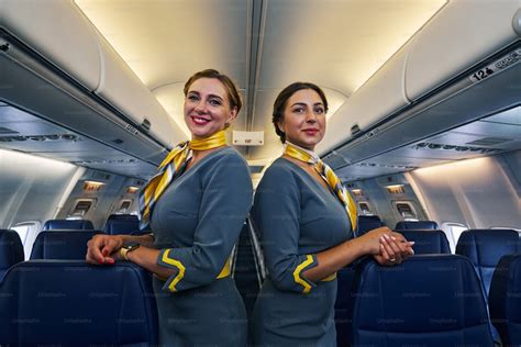 Two Beautiful Caucasian Elegant Professional Female Flight Attendants