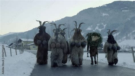 A Group Of Traditional Krampus Walk On Street In Gastein Austria