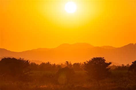 Bright Yellow Sunset In Hills Free Image Download